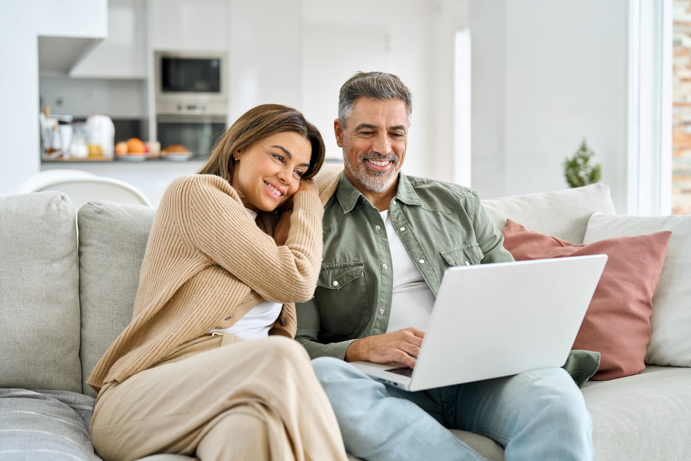 Couple on a couch using laptop